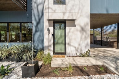 Doorway to property featuring stucco siding