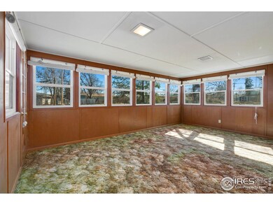 Light-filled sunroom overlooking and leading out to the fully-fenced backyard.