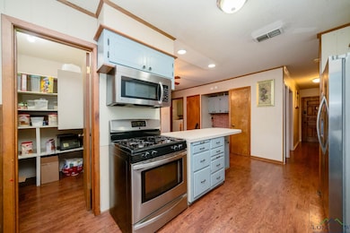 Kitchen featuring blue cabinetry, appliances with 