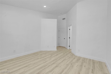 Unfurnished room featuring light wood finished flo