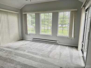 Florida room offers lots of windows and double sliders.