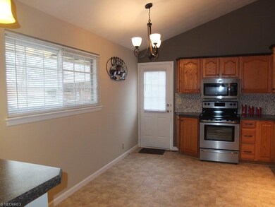Eat in kitchen with vaulted ceiling.