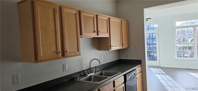 Kitchen featuring sink, stainless steel dishwasher, and light wood-type flooring