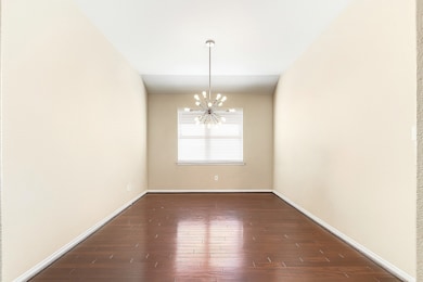 A view of the spacious formal dining room reveals the same wood flooring that runs throughout the home, with tile in the wet areas. The current owners are using this space as a home office, thanks to the large breakfast room the home offers. It’s another versatile space to suit your needs.