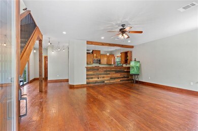 OPEN LIVING TO KITCHEN. CUSTOM BAR WALL PERFECT FO