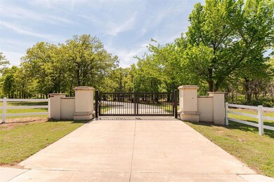 View of gate with a lawn and a fenced front yard