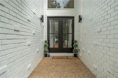 Double iron and glass doors take this 1970s house into 2025 with style!