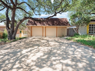 View of front facade with brick siding, fence, an