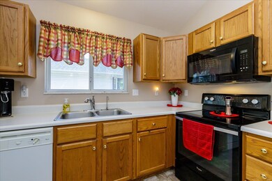 Kitchen with Electric Smooth Top Stove and Above t