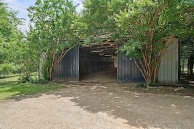 View of pole building with a detached carport
