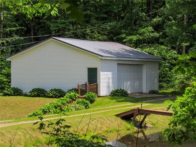 View of 2-car garage from private, dirt road.