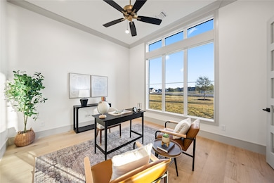 Office space featuring light wood-style floors and a ceiling fan
