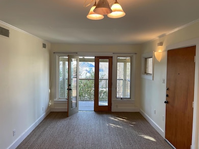 Entryway with french doors, carpet, baseboards, a