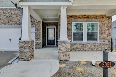 Entrance to property with a garage, a porch, and s