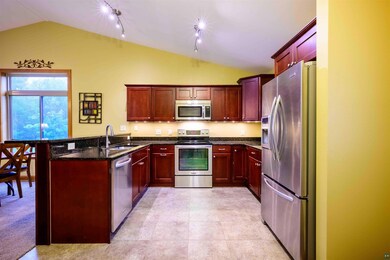Kitchen featuring stainless steel appliances, vaul