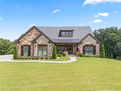 Craftsman inspired home featuring a front yard, brick siding, a metal roof, a porch, and a standing seam roof