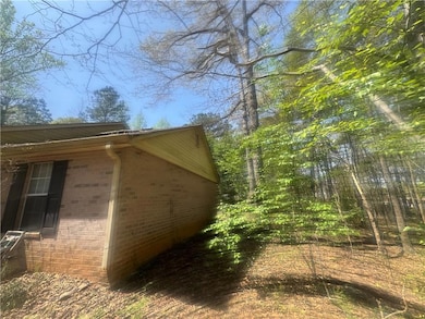 View of property exterior with brick siding