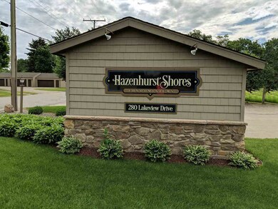Condo sign with garage to rear.