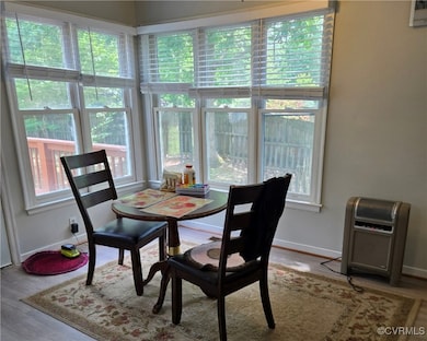 Dining space with baseboards and wood finished flo