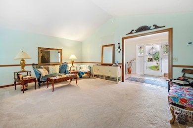 Sitting room featuring carpet floors and high vaul