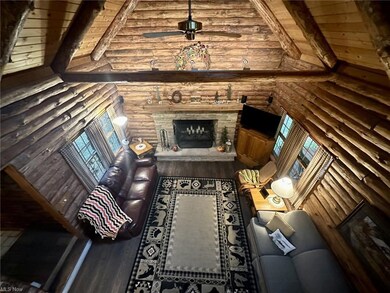Hardwood floored living room featuring vaulted cei