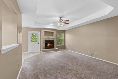 Living room features coffered ceiling and gas log fireplace.