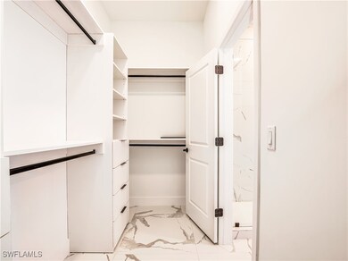 Spacious closet with light marble finish flooring