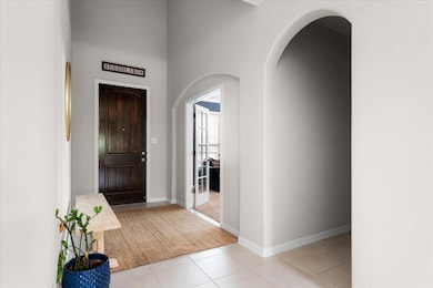 Foyer entrance featuring light tile patterned flo