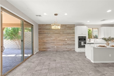 Kitchen featuring light countertops, double oven,