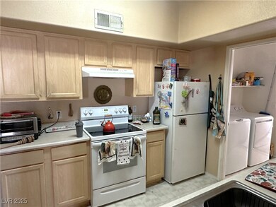 Kitchen with light countertops, visible vents, was