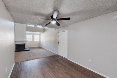 Unfurnished living room featuring a textured ceili