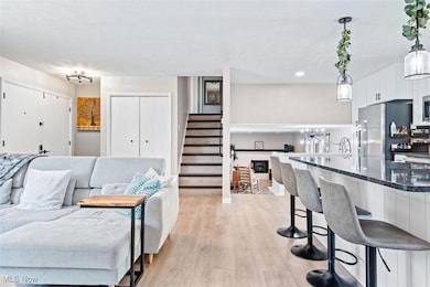 Living area featuring light wood finished floors and stairway
