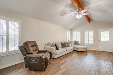 Living area featuring wood finished floors and a ceiling fan