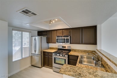Kitchen featuring stainless steel appliances, a tr