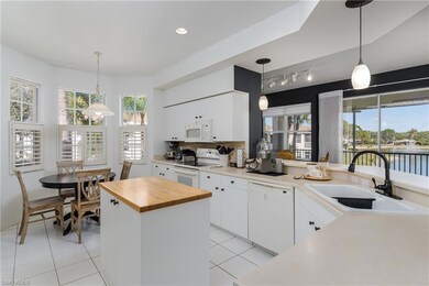 Kitchen featuring sink, white cabinetry, a water v
