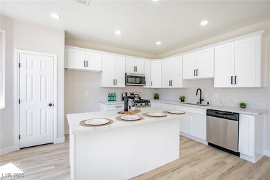 Kitchen with stainless steel appliances, a sink, l