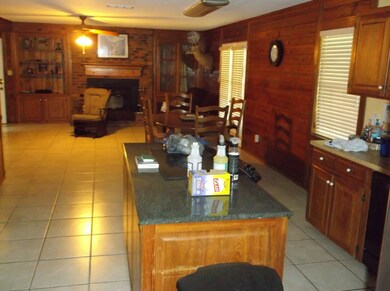 View looking from kitchen into den with brick fire
