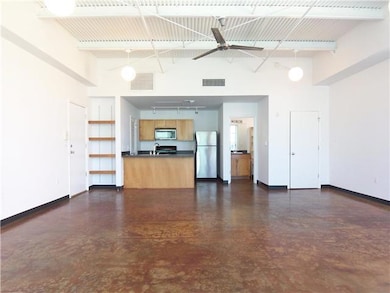 Unfurnished living room with finished concrete fl