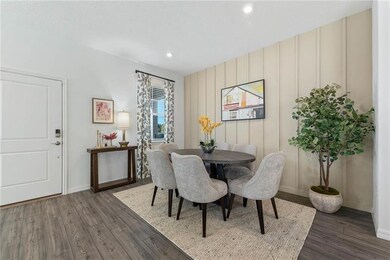 Dining space featuring dark wood-style flooring and recessed lighting