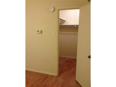 Corridor featuring baseboards and wood finished f
