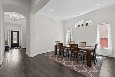 This dining room features tall windows, high ceili