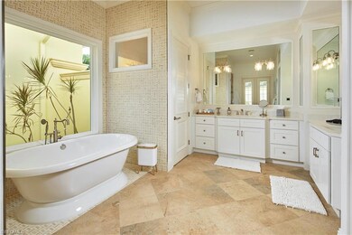 Bathroom with ornamental molding, tiled bath, a no