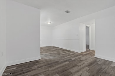 Spare room with dark hardwood / wood-style floorin