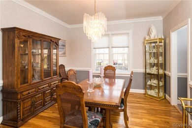 Formal Dining Room with hardwood, chair rail, crow