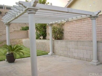 Backyard has blockwall fence, pergola