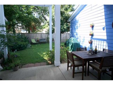 View of back yard and covered patio.