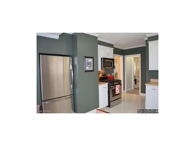 Stainless steel appliances accent the kitchen.