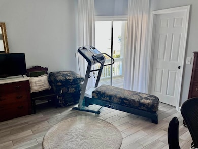 Exercise area featuring light wood finished floors