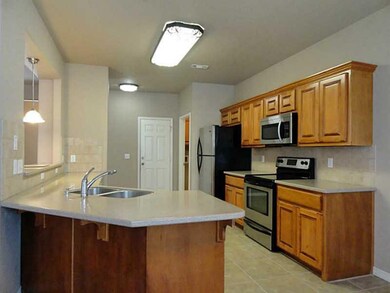 Kitchen. Solid surface counters and stainless steel appliances = great kitchen
