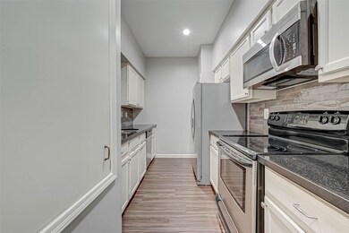 Kitchen with electric range and granite countertop